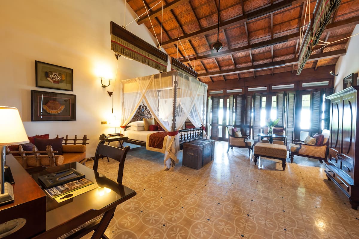 A traditional room with a bed, a desk, and a chair.