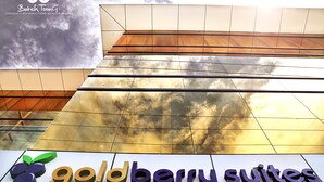 A hotel sign with the name "Goldberry Suites" and a logo with three stylized leaves. - Goldberry Suites & Hotel Mactan (Lapu-Lapu)