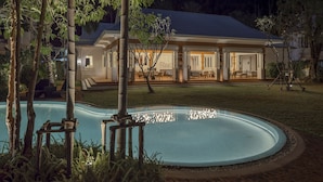 A pool with a clear edge, surrounded by a brick walkway. - The Pe La Resort, Phuket (Kamala)