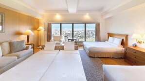 A hotel room with two beds, a sofa, a dining table, and a view of the city. - HOTEL MYSTAYS PREMIER Sapporo Park (Sapporo)