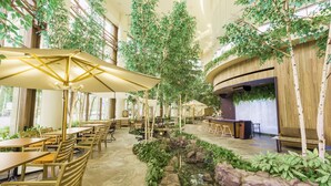 An indoor dining area with tables, chairs, and a small water feature. - HOTEL MYSTAYS PREMIER Sapporo Park (Sapporo)
