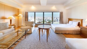 A hotel room with a bed, a sofa, a chair, a table, and a large window offering a city view. - HOTEL MYSTAYS PREMIER Sapporo Park (Sapporo)