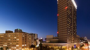 A high-rise hotel with multiple floors, illuminated windows, and a prominent sign at the top. - HOTEL MYSTAYS PREMIER Sapporo Park (Sapporo)