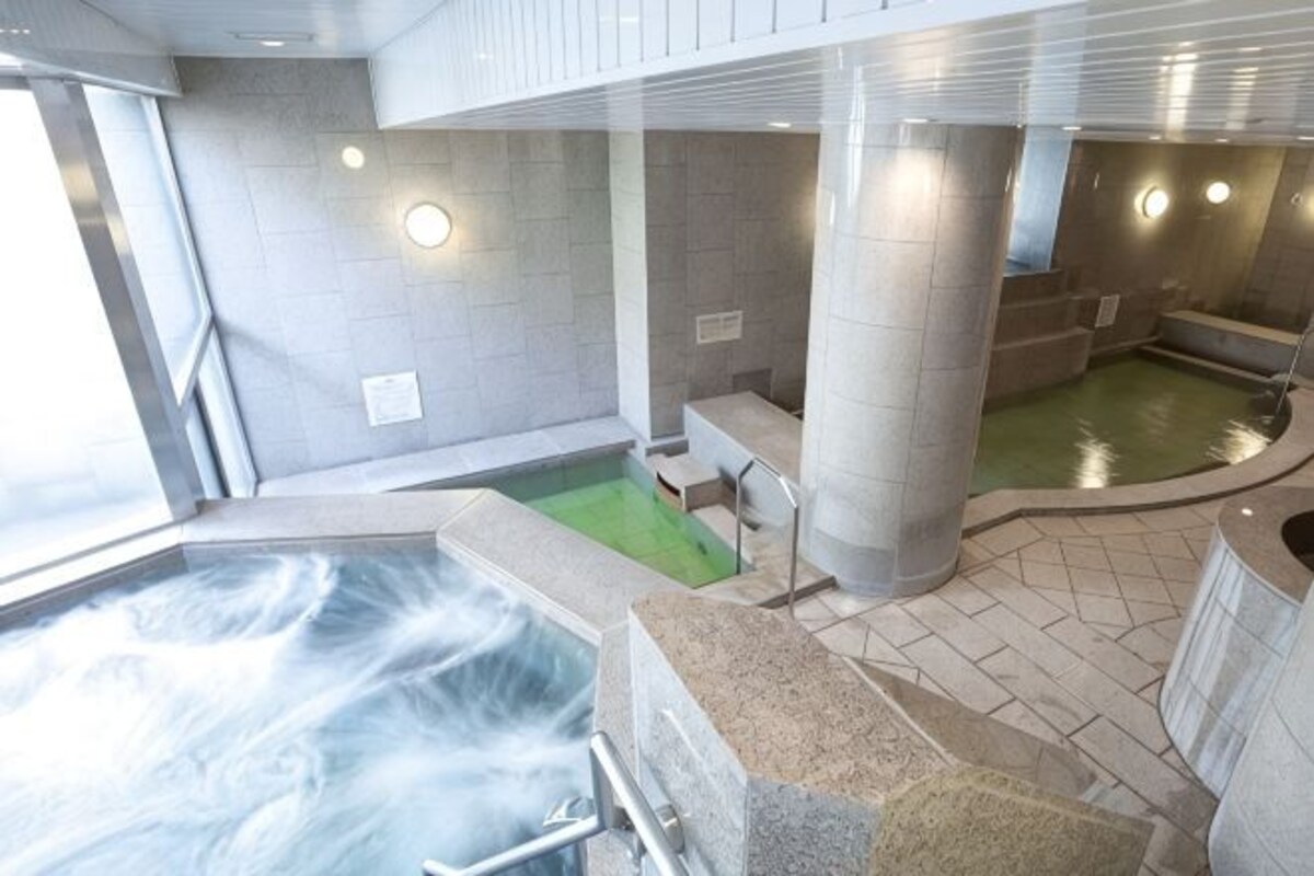 A spa area with a hot tub, a separate pool, and a seating area.