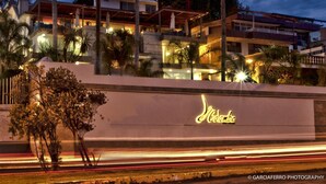 A hotel with a prominent 'Cambe' sign, modern architecture, and a well-lit facade. - Colombe Hotel Boutique (Xalapa)