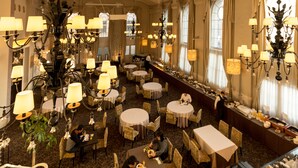 A spacious hotel lobby with multiple dining tables and chairs, elegant chandeliers, and large windows allowing natural light. - Matsumoto Marunouchi Hotel (Matsumoto)