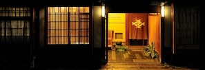 A traditional Japanese entrance with sliding doors and a wooden interior.