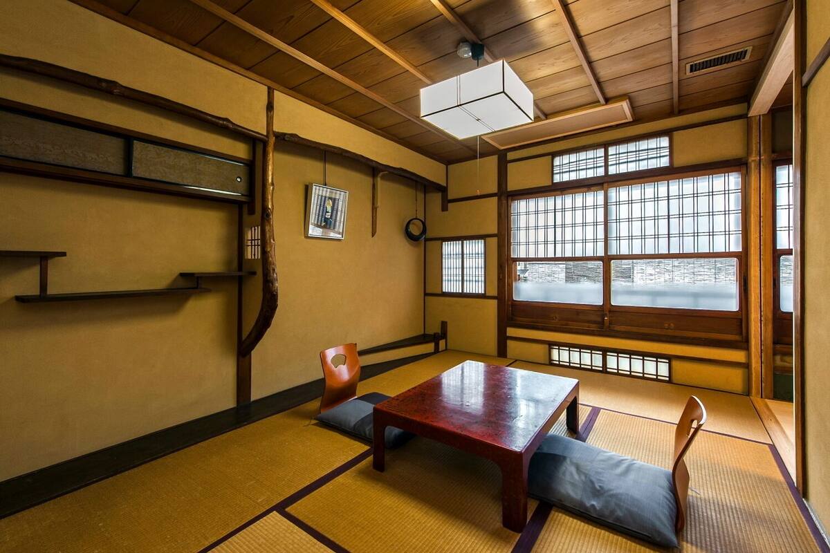 A traditional Japanese room with tatami flooring, a low wooden table, and sliding shoji doors.