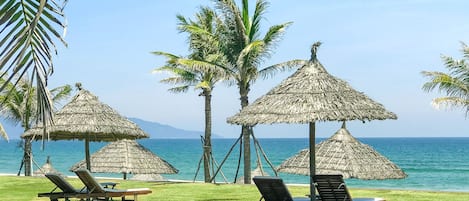 Private beach, white sand, sun loungers, beach umbrellas