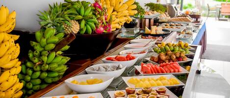 A buffet with various fruits and dishes.