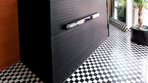 A reception desk with a checkered floor, a potted plant, and a window with blinds. - Bridal Tea House Hung Hom Gillies Avenue South (Kowloon)