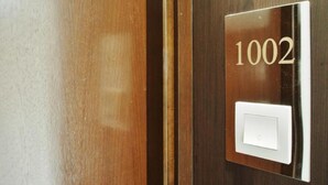 A door with a number plate displaying '1002' and a light switch. - Bridal Tea House Hung Hom Gillies Avenue South (Kowloon)