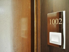 A door with a number plate displaying '1002' and a light switch. - Bridal Tea House Hung Hom Gillies Avenue South (Kowloon)