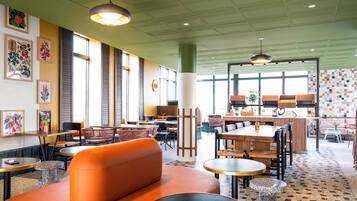 Relax in a spacious room with a variety of seating options, including a sofa, stools, and a dining table.