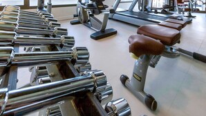 A gym with exercise equipment including dumbbells, treadmills, and weight machines. - Novotel Tunis (Tunis)