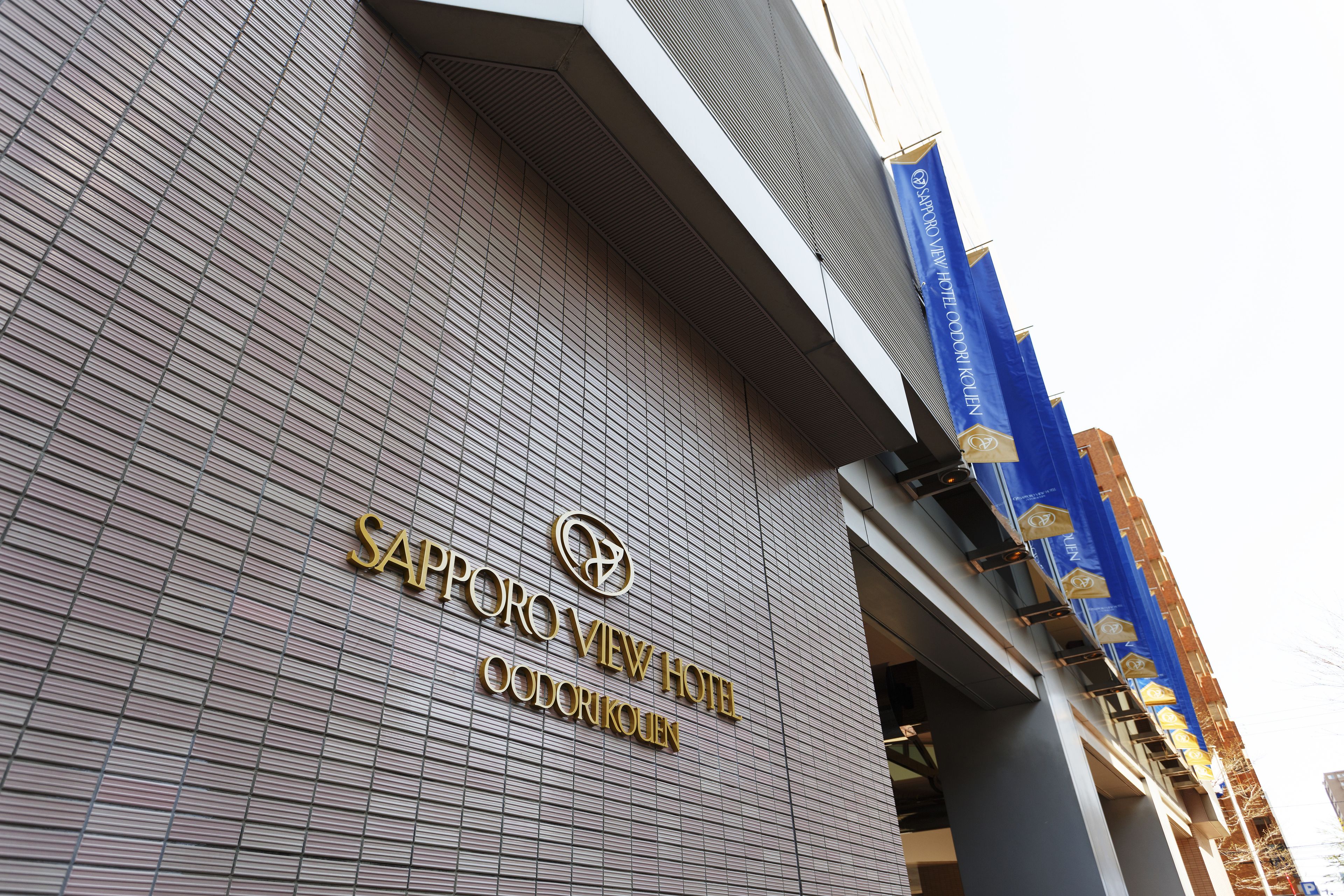 The exterior of the Sapporo View Hotel with a modern architectural design and a prominent sign.