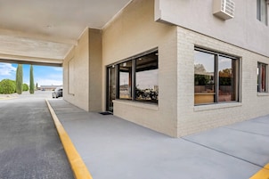 A modern building with large windows and a concrete floor.