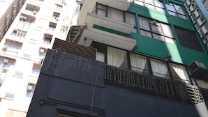 A tall building with multiple floors, large windows, and a green awning. - Bridal Tea House Hotel Yau Ma Tei Arthur Street (Kowloon)
