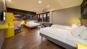 A hotel room with two beds, a sofa, a desk, and a cityscape mural. - Travelodge Georgetown (George Town)
