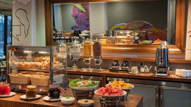 A buffet with various food items, including fruits, salads, and pastries. - Travelodge Georgetown (George Town)