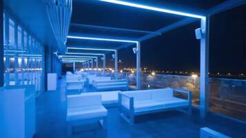 Relax in a covered outdoor seating area with city views.