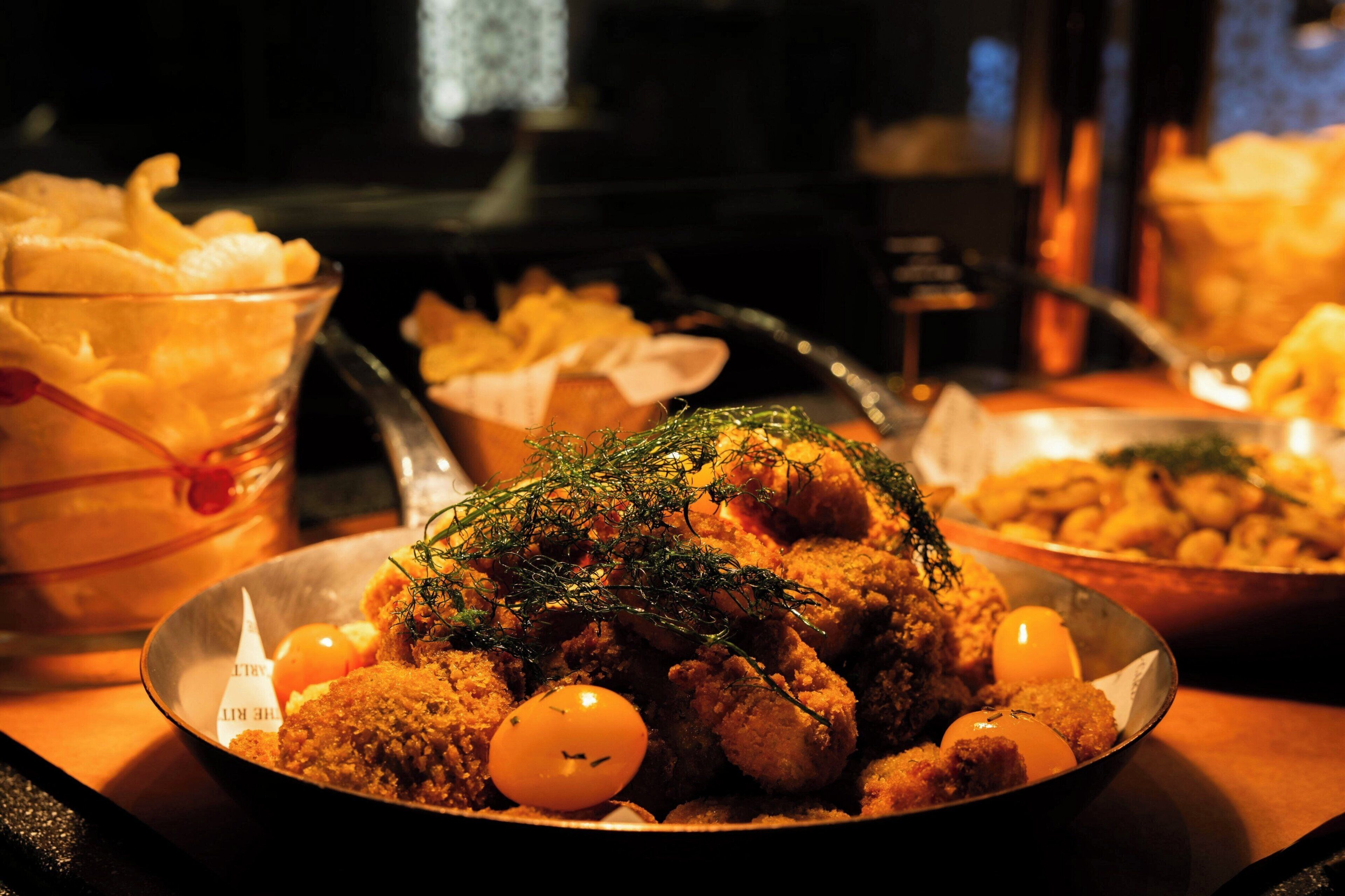 A table with various dishes, including a central dish garnished with herbs and small eggs.