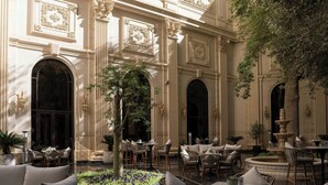An elegant courtyard with ornate columns, a fountain, and comfortable seating areas. - The Ritz-Carlton, Riyadh (Riyadh)