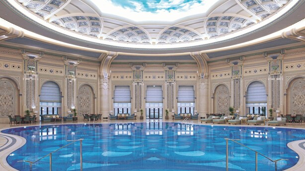 A large indoor swimming pool with ornate ceiling and walls, surrounded by seating areas and large windows. - The Ritz-Carlton, Riyadh (Riyadh)