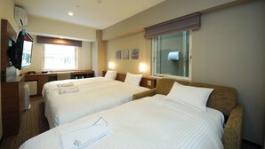 A hotel room with two beds, a desk, a television, and a window with blinds. - Sotetsu Fresa Inn Hamamatsucho Daimon (Tokyo)
