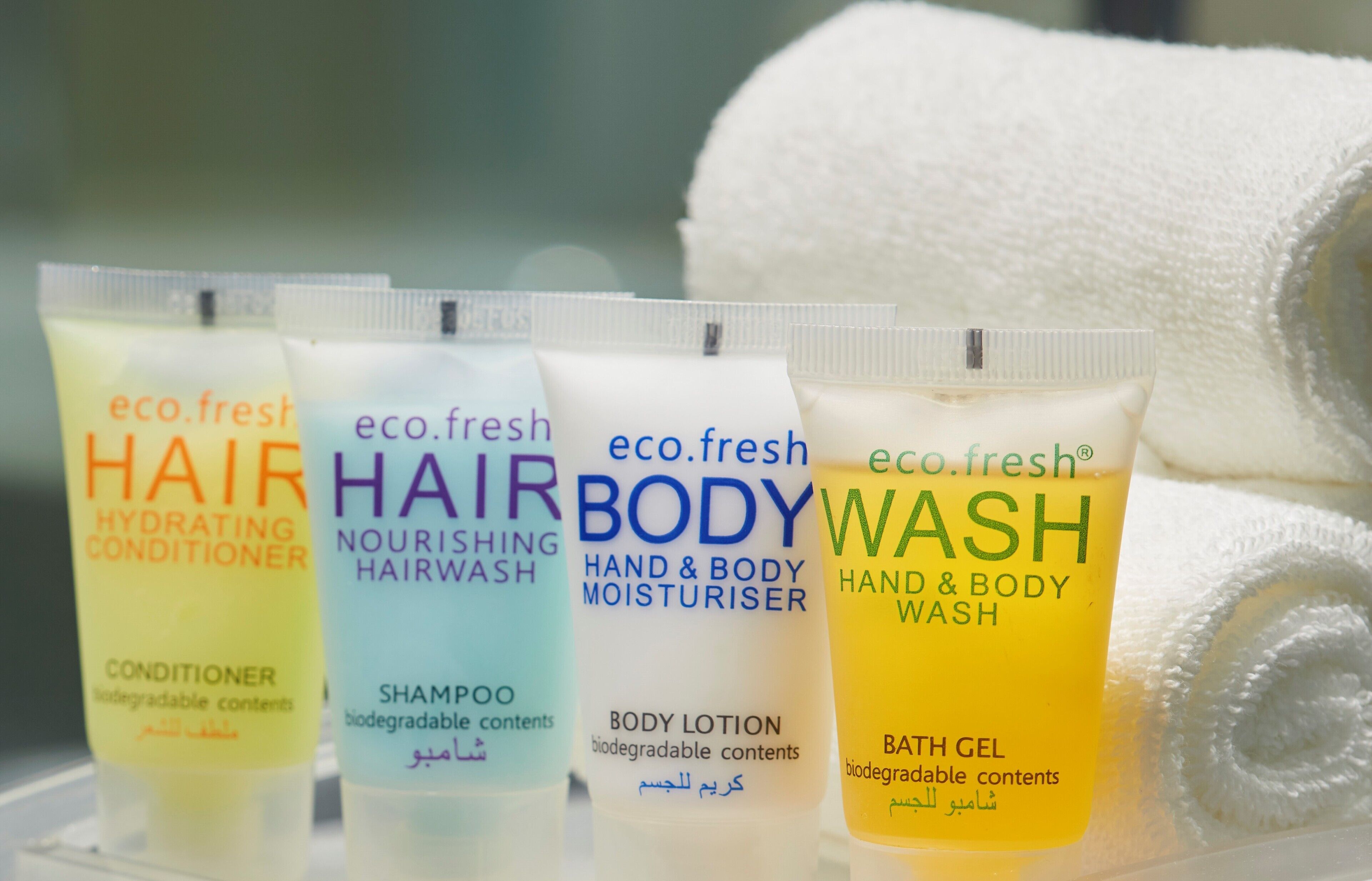 Four bottles of eco.fresh hair and body care products.