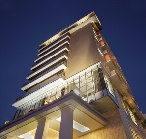 A modern building with multiple floors, large windows, and a flat roof. - Hotel Santika Jemursari Surabaya (Surabaya)