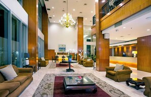 A spacious lobby with a reception desk, comfortable seating, and a chandelier. - Hotel Santika Jemursari Surabaya (Surabaya)