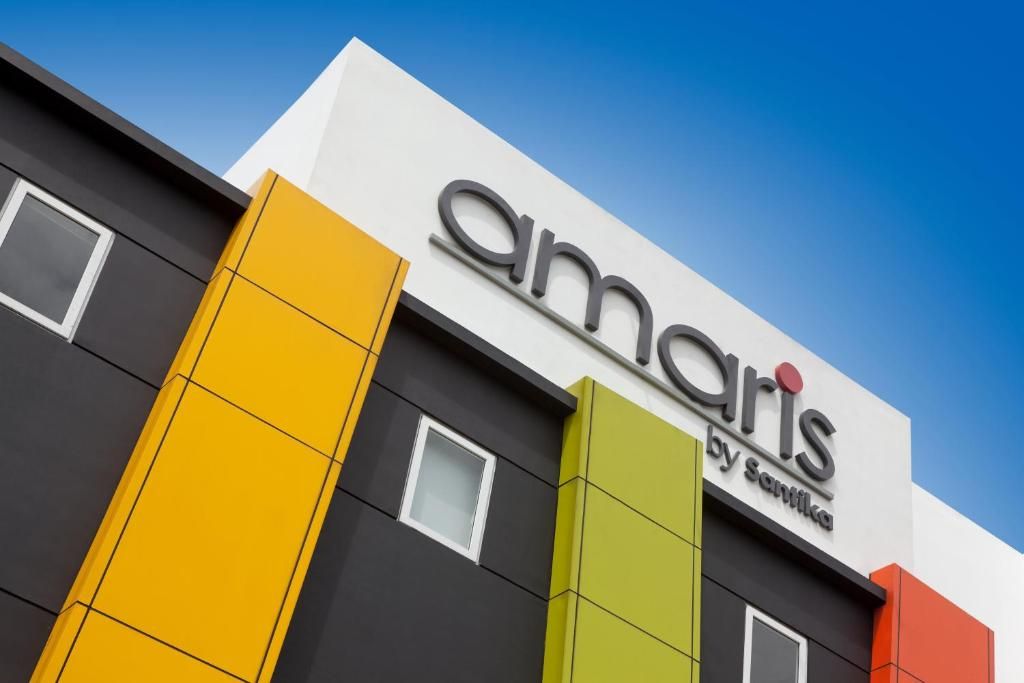 A building with a sign that reads 'Amaris by Santika.'