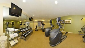 A gym with treadmills, elliptical machines, and dumbbells. - Holiday Inn Express and Suites Williston by IHG (Williston)