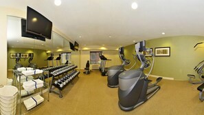 A gym with treadmills, elliptical machines, and dumbbells. - Holiday Inn Express and Suites Williston by IHG (Williston)