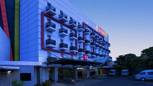 A modern hotel with a distinctive facade featuring a grid-like pattern and balconies. - Amaris Hotel - Bandara Soekarno Hatta (Tangerang)