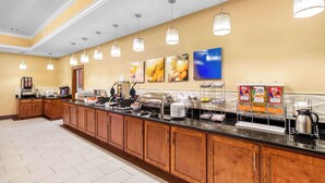 A buffet setup with various food items and a coffee station. - Comfort Suites at Katy Mills (Katy)