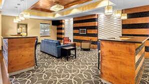 A hotel lobby with a reception desk, seating area, and a patterned carpet. - Comfort Suites at Katy Mills (Katy)