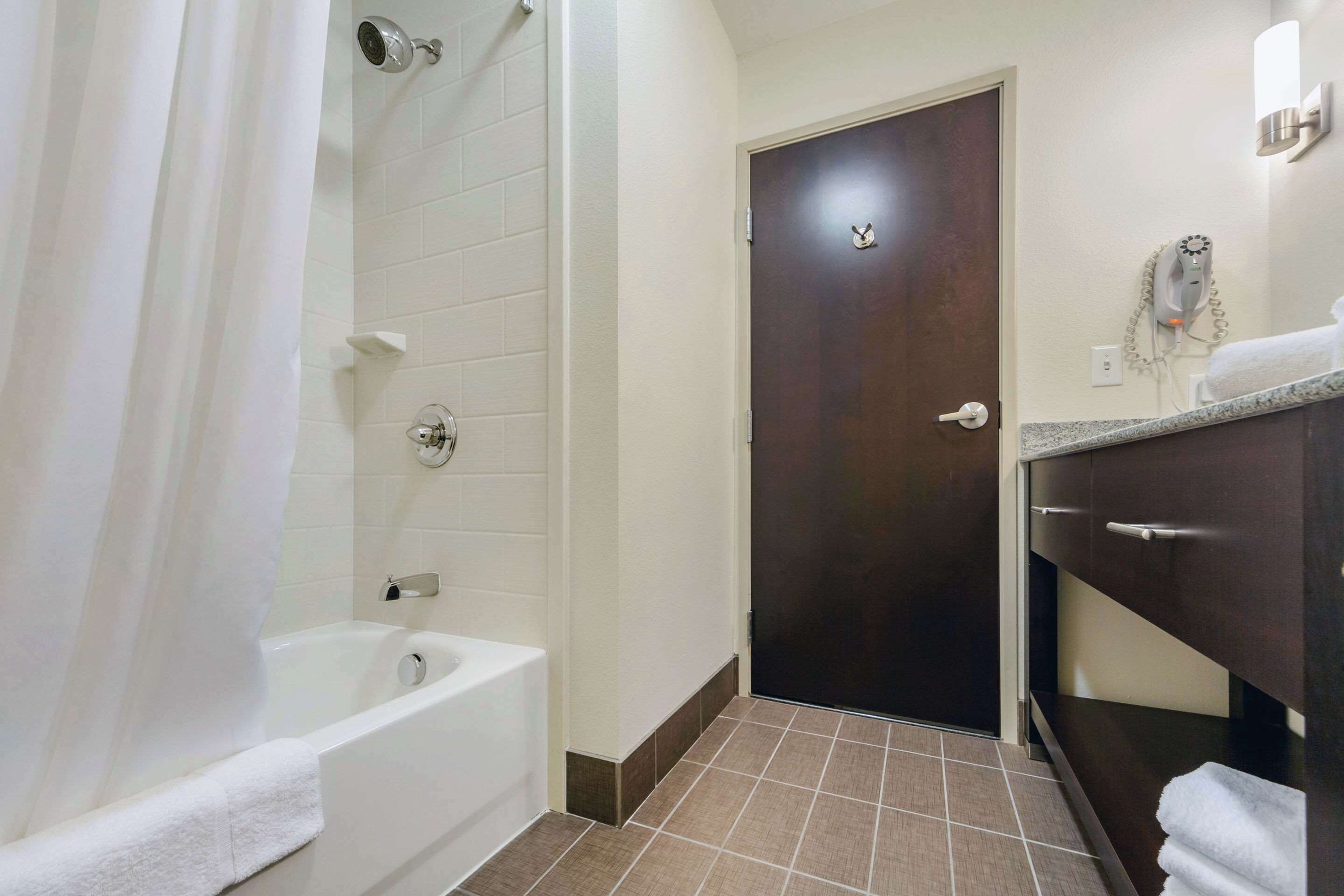 hypo-allergenic bedding, desk, laptop workspace, blackout curtains