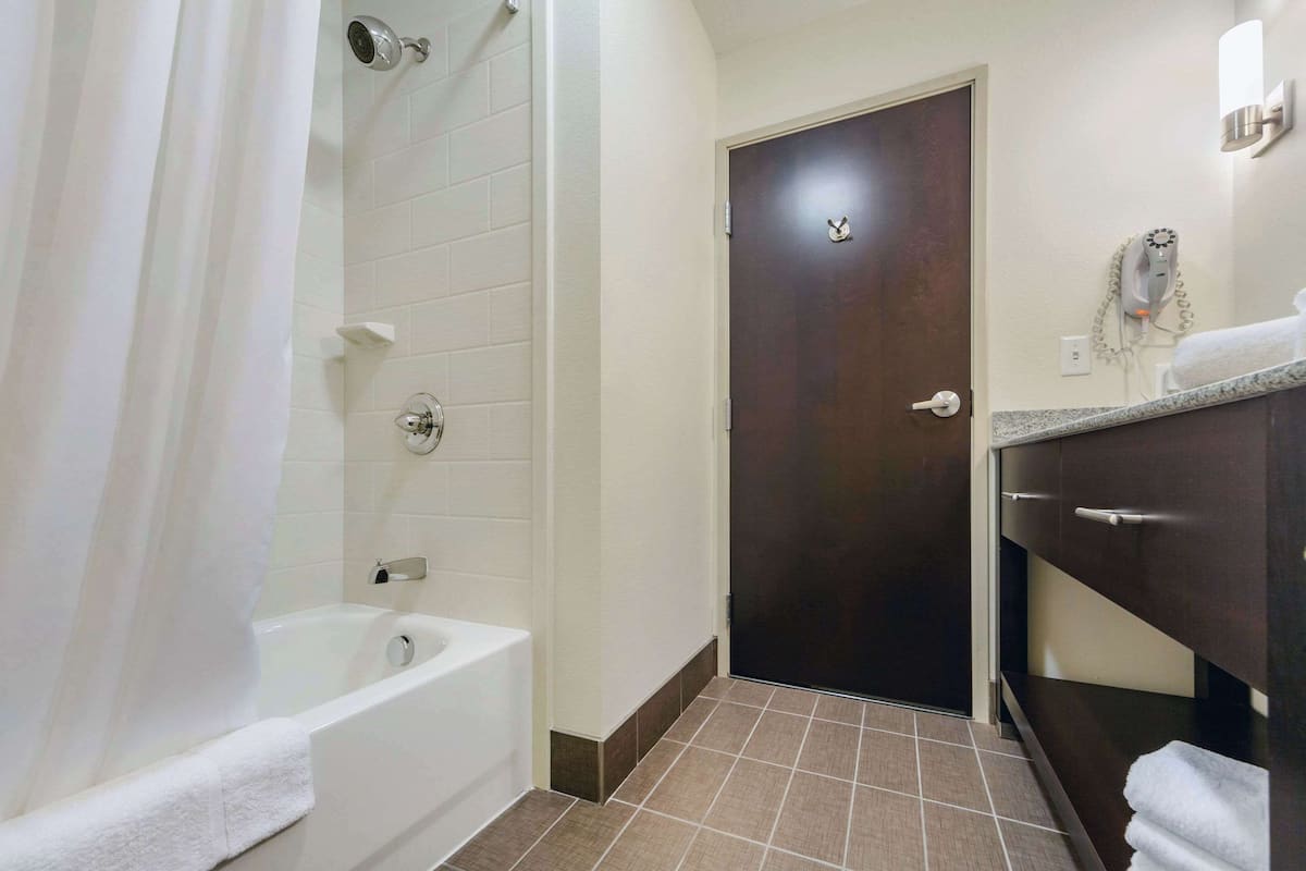 hypo-allergenic bedding, desk, laptop workspace, blackout curtains