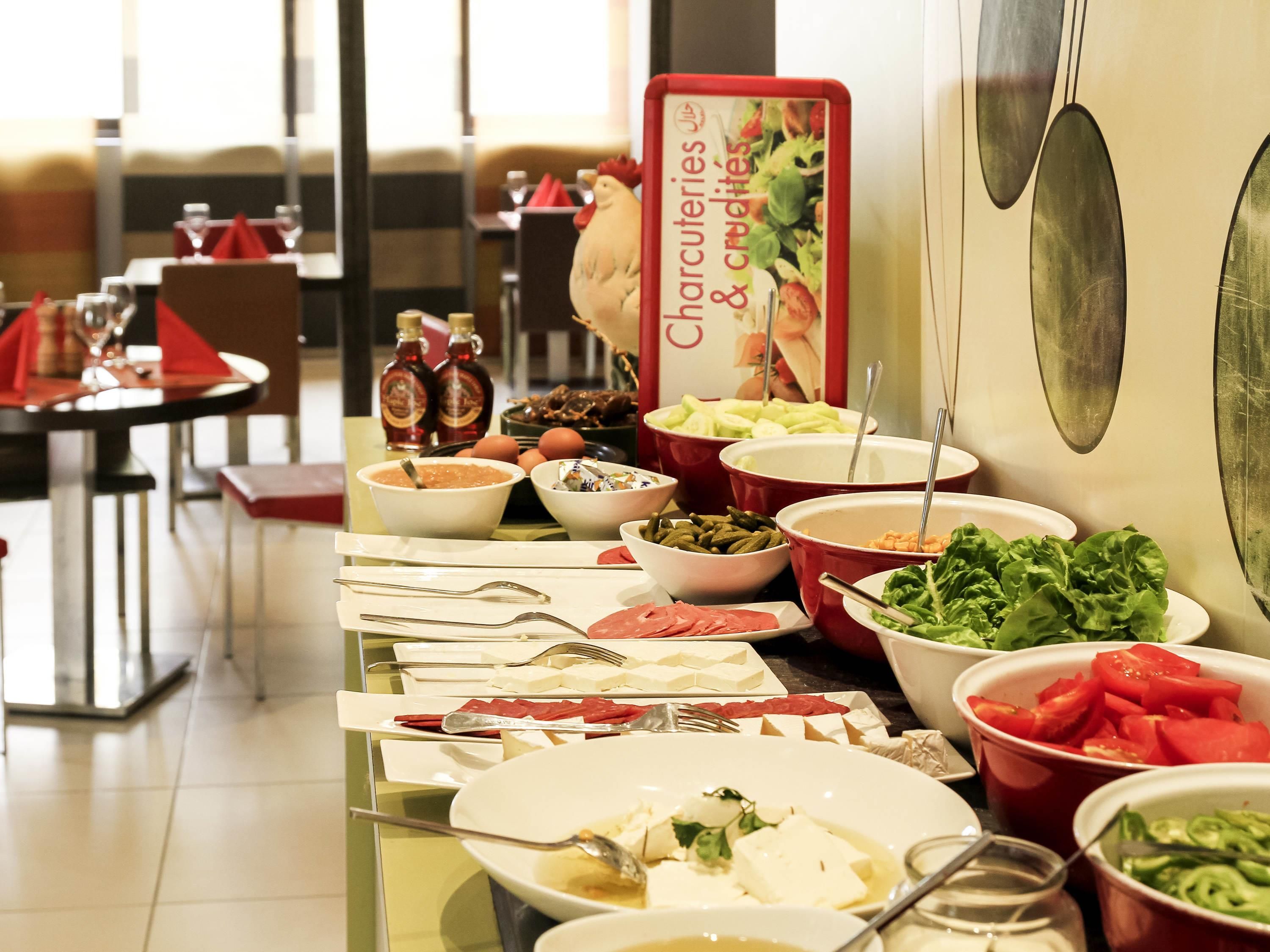 A buffet with various food items and a sign indicating charcuteries & crudités.