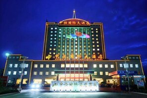A large hotel building with multiple floors and a prominent entrance.