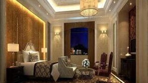 A hotel room with a large bed, a sitting area with a chair and a small table, a television, and a decorative wall. - Ramada Plaza Shaoguan City Centre (Shaoguan)