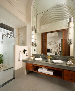 A modern bathroom with a glass-enclosed shower, two sinks, and a large mirror with decorative elements. - Taj Bekal Resort & Spa, Kerala (Hosdurg)