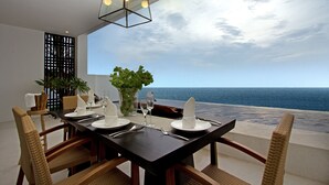 A dining table set with white plates, silverware, and glassware, overlooking the ocean. - Montigo Resorts Nongsa (Batam)