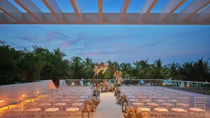 An outdoor seating area with rows of chairs and a decorative aisle. - Royal Palm South Beach Miami, a Tribute Portfolio Resort (Miami Beach)