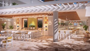 Un espacio interior moderno con una zona de bar, asientos y suelo estampado.