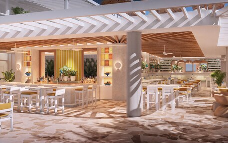 A modern indoor space with a bar area, seating, and a patterned floor.