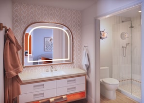 A bathroom with a vanity, a mirror, a towel rack, a toilet, and a shower enclosure. - Royal Palm South Beach Miami, a Tribute Portfolio Resort (Miami Beach)