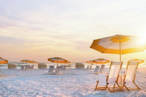 A beach with rows of sun loungers and umbrellas, some with towels. - Royal Palm South Beach Miami, a Tribute Portfolio Resort (Miami Beach)